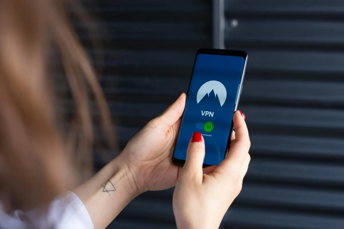 smartphone in hand showing security app