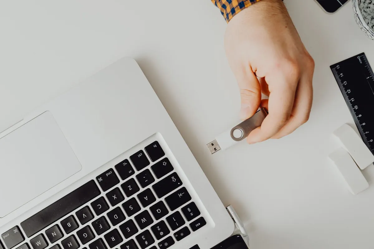 USB drive being plugged into laptop